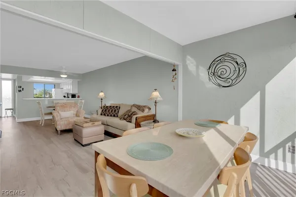 a living room with couches and a table with wooden floor