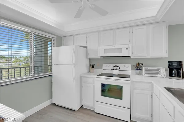 a kitchen with a stove top oven sink and refrigerator