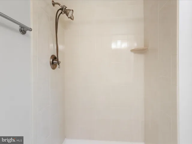 a living room with furniture and a refrigerator