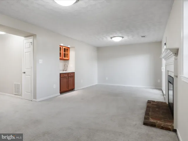 a view of empty room with window and fireplace