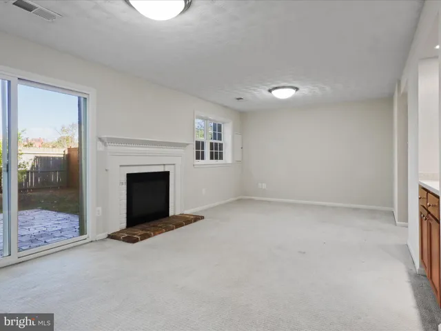 a view of a house with a yard and wooden fence