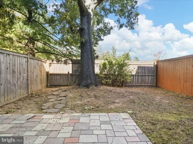 front view of a brick house with a yard