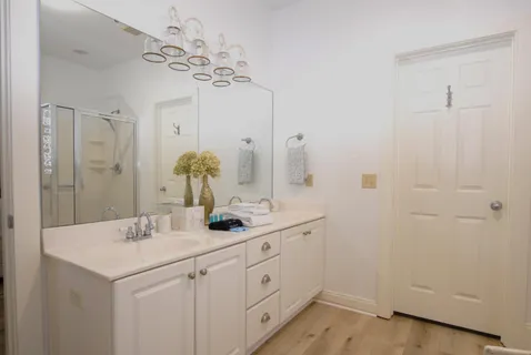 a bathroom with a double vanity sink and a mirror