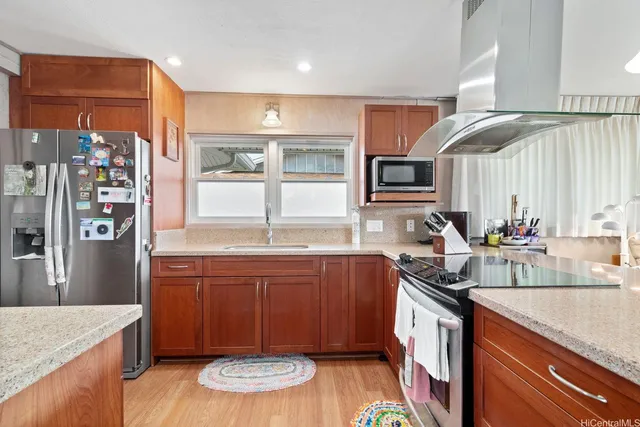 a kitchen with stainless steel appliances granite countertop a sink stove and refrigerator