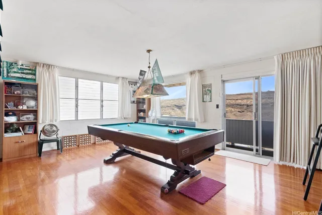 a room with furniture pool table and flat screen tv
