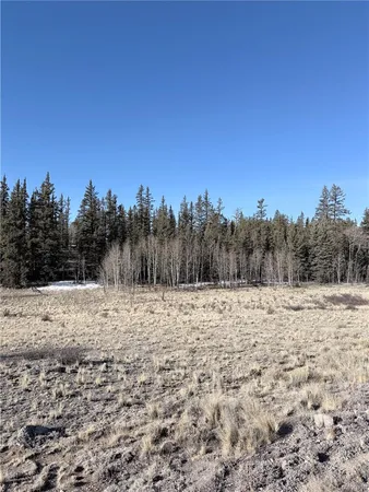 a view of dirt road and a building in the background