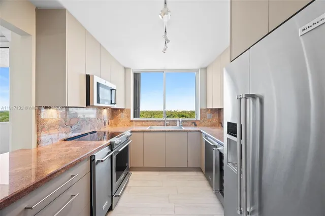 a kitchen with a sink a refrigerator and window