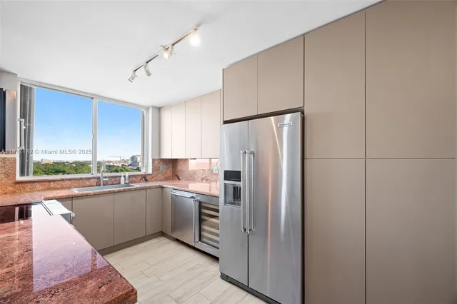 a kitchen with granite countertop a stove and a microwave