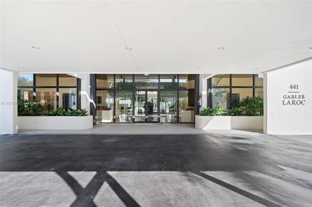 a view of lobby with a floor to ceiling window and potted plants