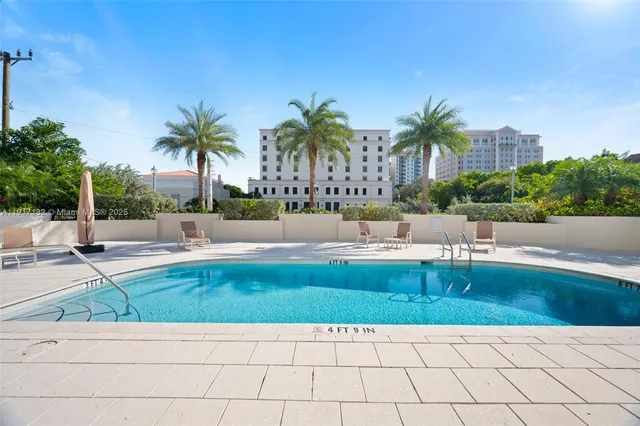 a view of a swimming pool with chairs
