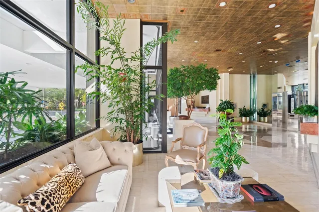 a view of a patio with couches table and chairs and potted plants