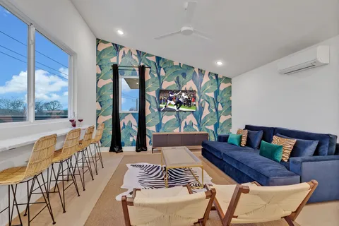 a living room with furniture and a floor to ceiling window