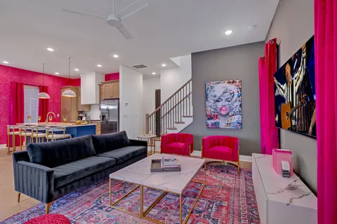 a kitchen with stainless steel appliances a dining table chairs and window
