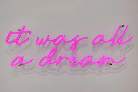 a bedroom with a large bed and a wooden floor