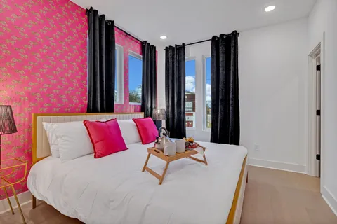 a bedroom with a bed and a lamp