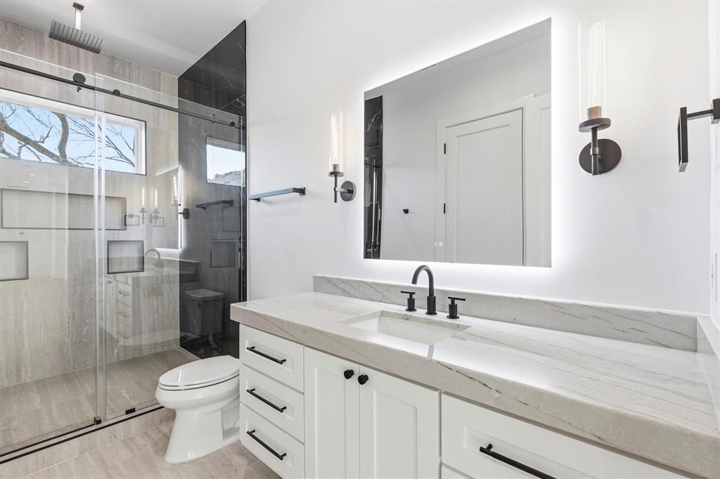 6257 Turner Way Dallas, TX 75230 - Photo 27 of 39 a bathroom with a sink a toilet and shower