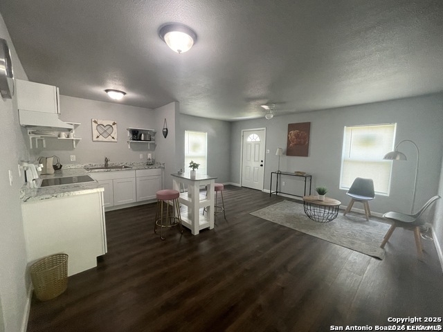 422 Florence Street Uvalde, TX 78801 - Photo 2 of 11 a living room with furniture a dining table and chairs next to window