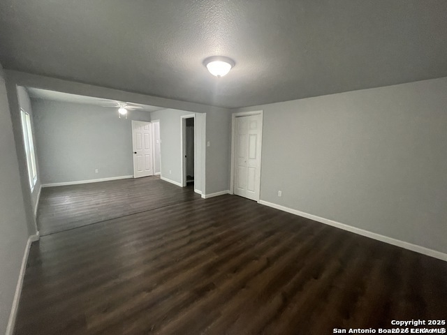 422 Florence Street Uvalde, TX 78801 - Photo 6 of 11 an empty room with wooden floor and windows