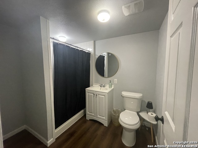 422 Florence Street Uvalde, TX 78801 - Photo 7 of 11 a bathroom with a toilet a sink and mirror