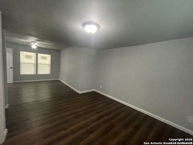 422 Florence Street Uvalde, TX 78801 - Photo 8 of 11 an empty room with wooden floor and windows