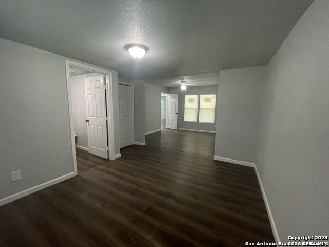 422 Florence Street Uvalde, TX 78801 - Photo 10 of 11 an empty room with wooden floor and windows