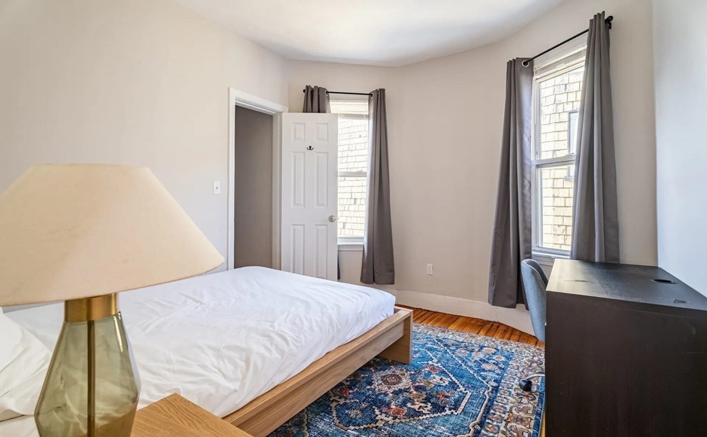 33 Edison Green, Unit 3 Boston, MA 02125 - Photo 4 of 11 a bedroom with a bed and a window with rug