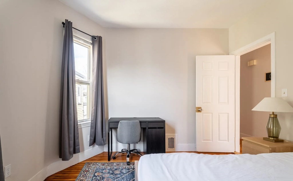 33 Edison Green, Unit 3 Boston, MA 02125 - Photo 5 of 11 a bedroom with a bed and a chair