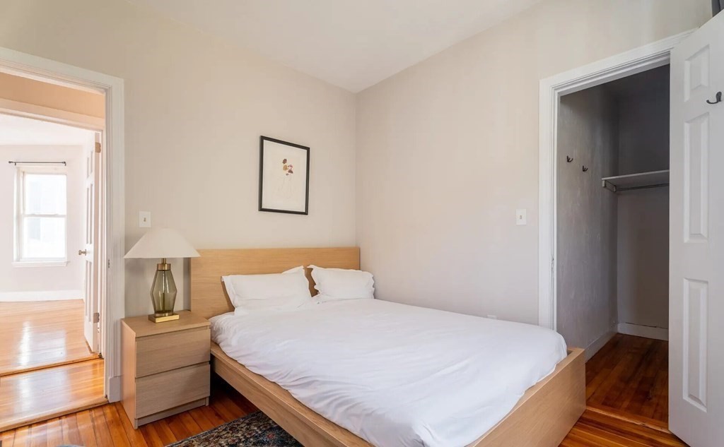 33 Edison Green, Unit 3 Boston, MA 02125 - Photo 6 of 11 a bedroom with a bed and painting on the wall