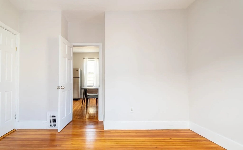 33 Edison Green, Unit 3 Boston, MA 02125 - Photo 7 of 11 a view of empty room with wooden floor