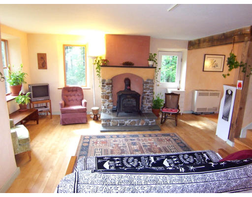 92 Dudleyville Road Leverett, MA 01054 - Photo 8 of 29 a living room with furniture and a fireplace