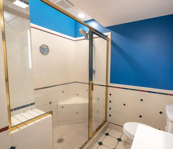 a bathroom with a shower and a sink