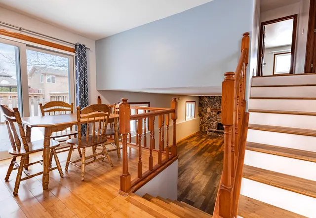 a view of a dining room with furniture a chandelier and wooden floor