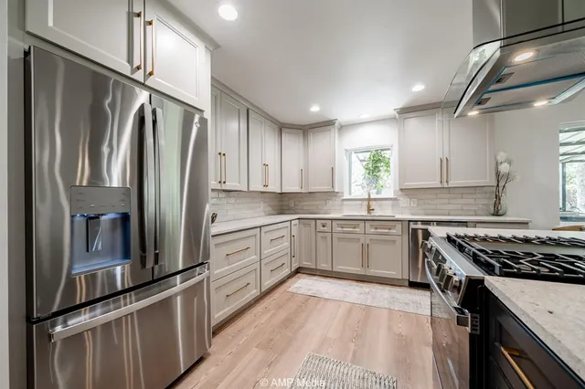 a kitchen with stainless steel appliances granite countertop a stove and a granite counter top