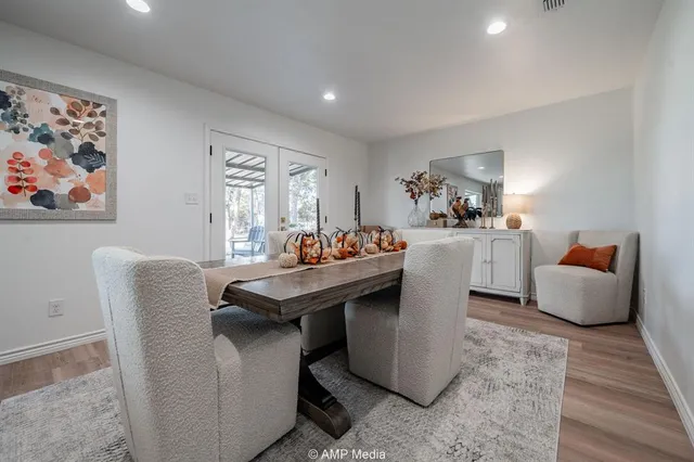 a spacious bedroom with a bed a couch and a dresser