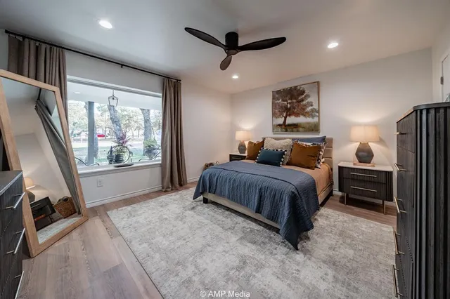 a bathroom with a granite countertop sink a toilet and a mirror
