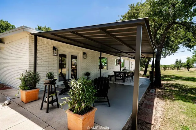 a view of a house with backyard porch and sitting area