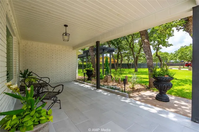 a view of a lobby with a bench and potted plants