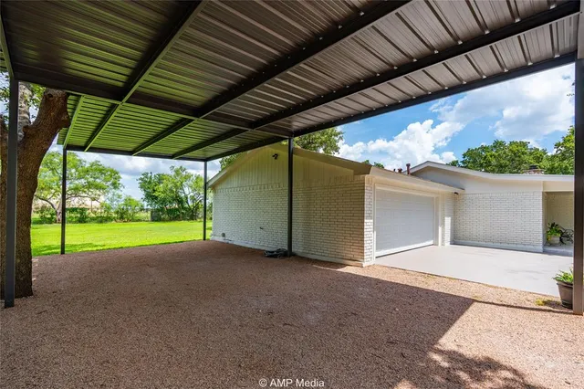 front view of a house with a yard and potted plants