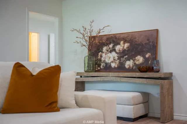 a living room with furniture a flat screen tv and a couch