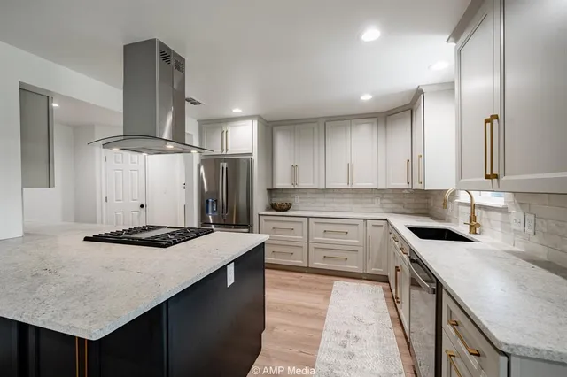 a kitchen with stainless steel appliances granite countertop a sink stove and cabinets