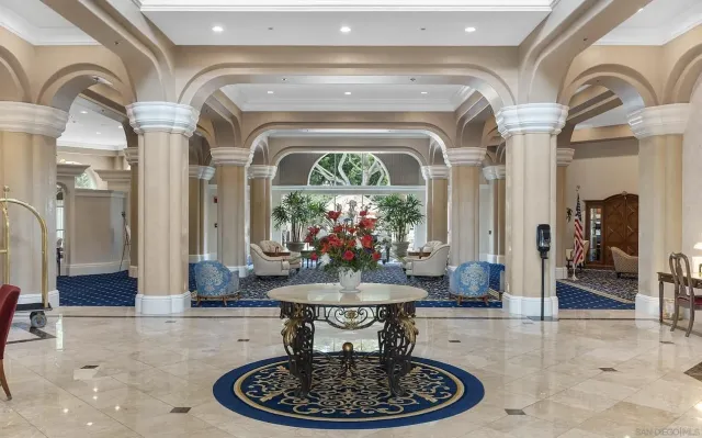 a lobby with furniture and a chandelier