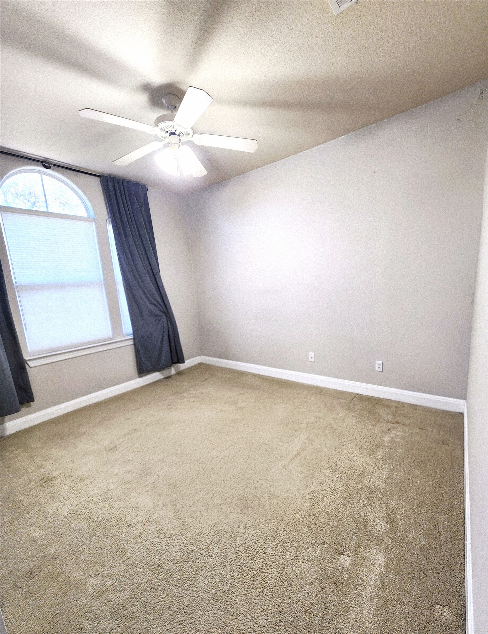152 Silver Hawk Court Dripping Springs, TX 78620 - Photo 26 of 31 an empty room with a chandelier fan and windows