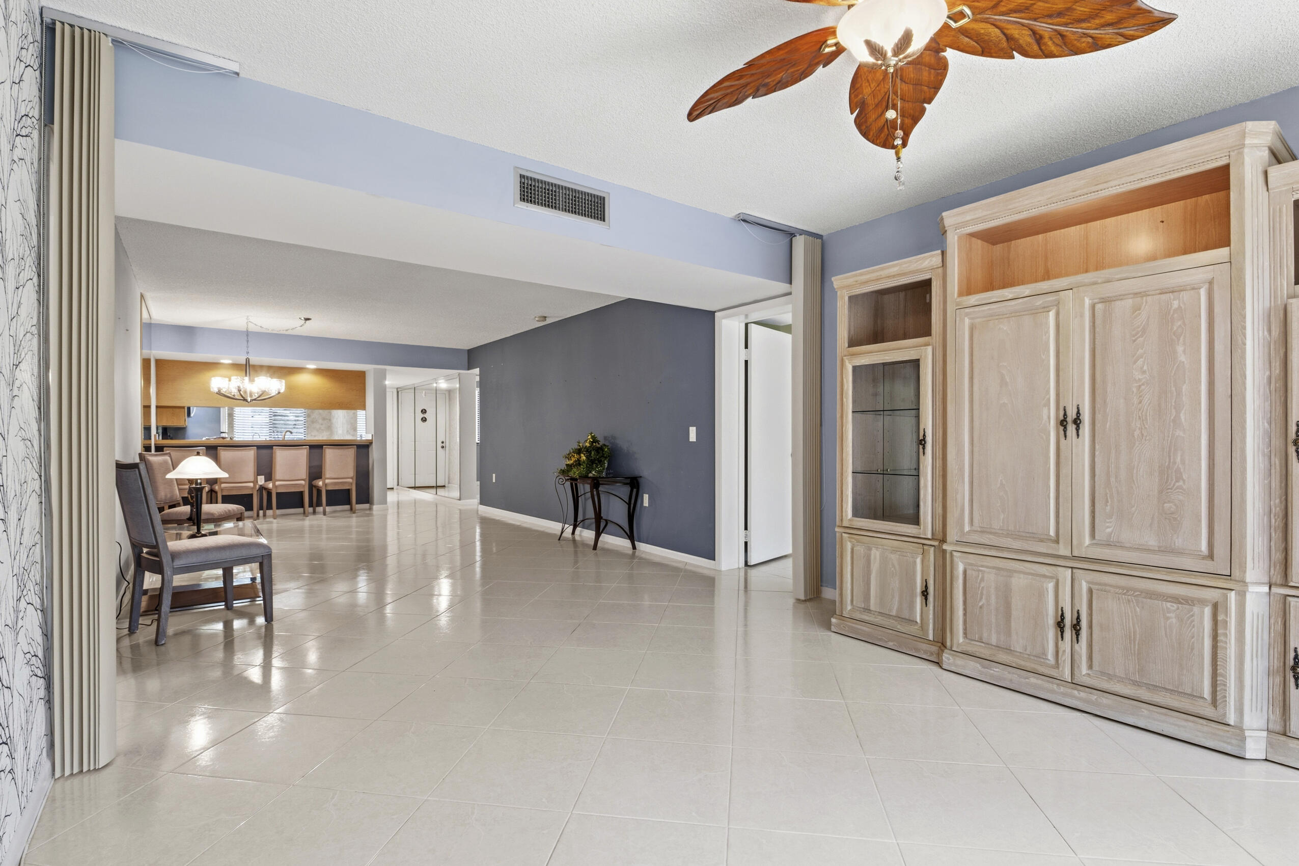 6145 Balboa Circle, Unit 103 Boca Raton, FL 33433 - Photo 10 of 31 a view of a livingroom with furniture wooden floor and window