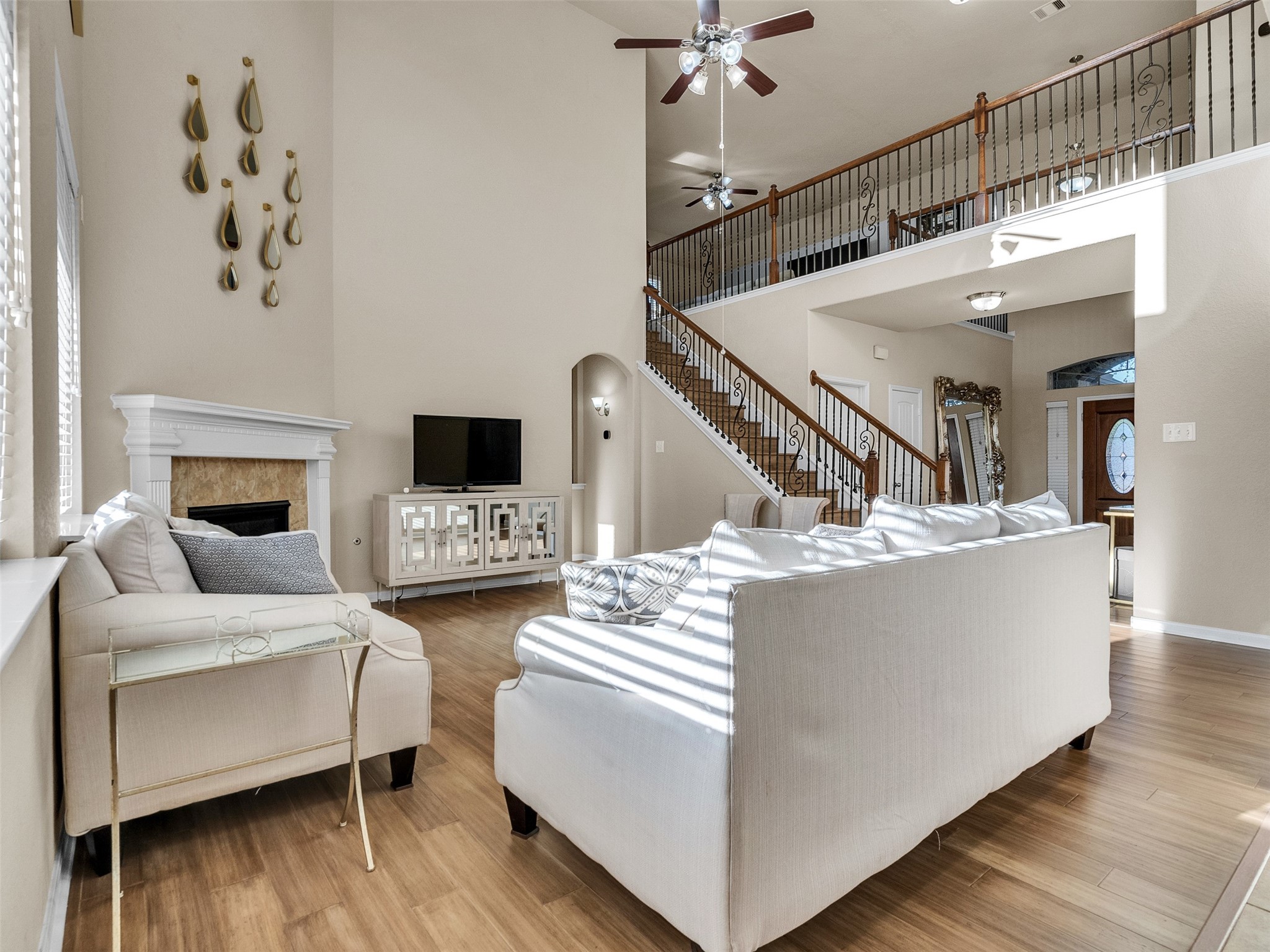 522 Summer Mist Lane Rosenberg, TX 77469 - Photo 3 of 36 This perspective highlights the impressive scale and seamless flow of the home's open-concept design, showcasing how the living area connects to the grand entryway and upper level