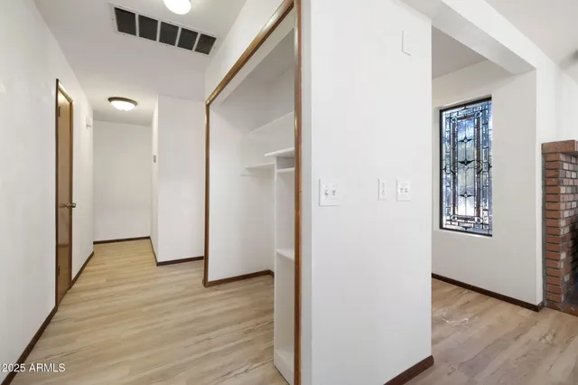 a view of a room with wooden floor and wardrobe