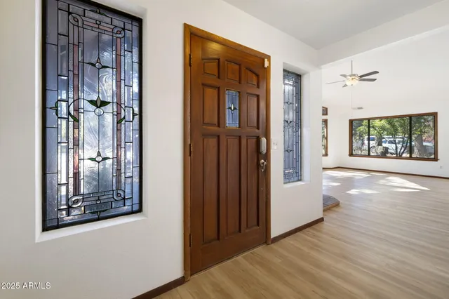 a view of an entryway with wooden floor