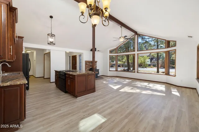 a view of a kitchen with furniture and a ceiling fan