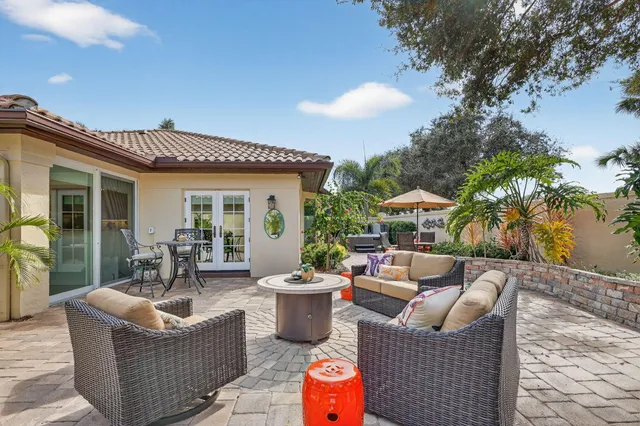 an aerial view of residential houses with outdoor space and trees