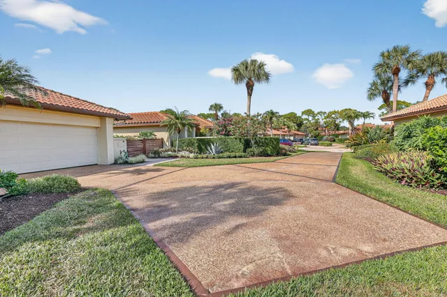 a front view of a house with a yard and a garden