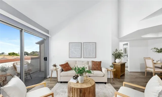 a living room with furniture and a floor to ceiling window